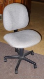 Rolling padded office chair has adjustable back and height. Chair is 37