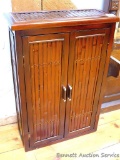 Cute little bamboo cabinet with 2 doors on the front with adjustable shelves inside; measures