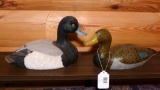 Two wooden hand painted ducks. One is a Bluebill from the Loon Lake Decoy Co 341/2900. One is signed