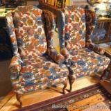 Pair of sturdy and oddly charming wing back chairs, upholstery is in good condition. One has some