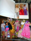 Six Barbies and a Ken doll, plus clothes , shoes, and a carry case. Case is 13-1/2