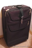 Wheeled suitcase has an extending handle. Measures 28