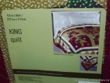 King sized Christmas patterned quilt is new in package.