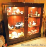 Very large antique display case with adjustable shelves and lights. We think it's primarily black