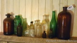 Fourteen vintage glass bottles including Coca Cola, Hi-lex, milk bottles, more. Most are dirty but