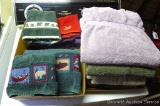 Assorted bathroom linens including hand towels, bath towels, wash cloths.