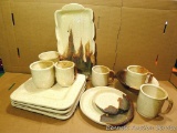 Fourteen pcs. of hand made yellow-tan dinnerware by Irene Gimeno. All pieces in good condition.