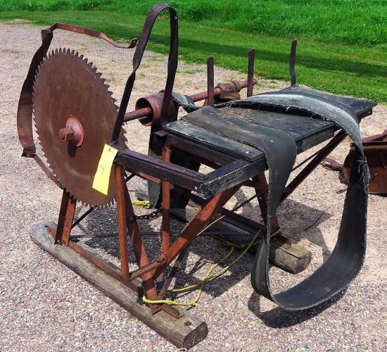 Belt driven buzz saw is 4' x 5' x 3' and is mounted on wooden shoes. Blade is 26" diameter. Bearings