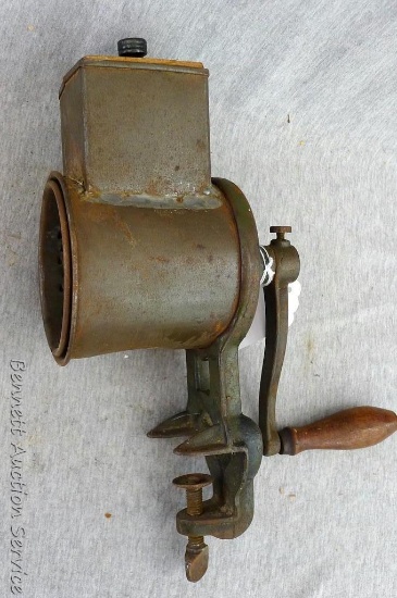 Antique metal Climax hand crank shredder is 12" tall. Clamps on to table top.