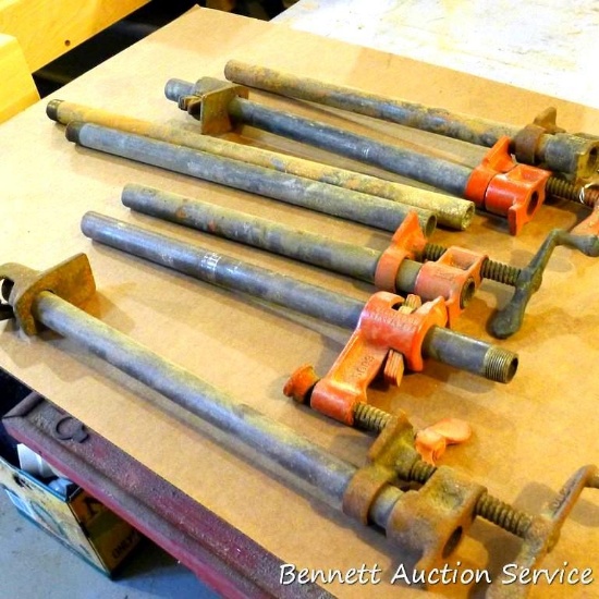 Two 3/4" Pony pipe clamps with 18" pipes, plus three more similar that are missing the sliding jaw.