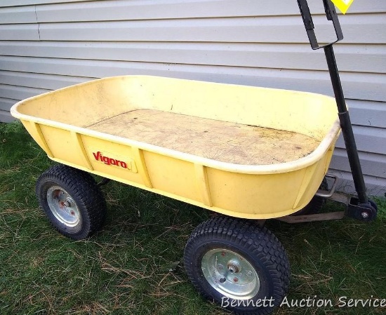 Vigoro lawn cart can be pulled by hand or hitched to lawn tractor by reversing the handle. Approx.