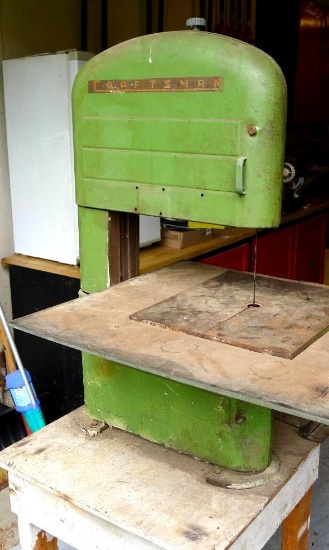 Craftsman band saw has a 12-1/2" throat. Table with extension is 26" x 22". Top blade guide is