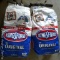 Two unopened value size bags of Kingsford original charcoal briquets, plus a 40