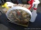Bird themed outdoor thermometer, table leg, and a couple of spray bottles. Thermometer is 12-1/2
