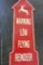 Metal arrow sign says 