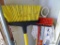 Quickie Jobsite, Libman, and other brooms, mops, marker bar, and a bucket. Tallest is 56