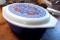 2-1/2 quart Pyrex covered casserole in good condition. Lid has a pretty design, bottom is blue.