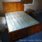 Full sized wooden bed frame with older mattress and box spring. Great for a cabin. Head board stands