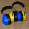 Peltor ear protection muffs. Blue pair is marked Peltor Bull's Eye Ultimate 10, yellow pair is