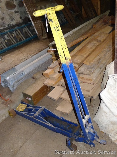 Heavy duty floor hydraulic floor jack is approx. 4' long. Raises and lowers.