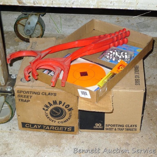 Full box of Champion sporting clays; another box of clays 2/3 full; 3 hand clay throwers; pkg. of 6"
