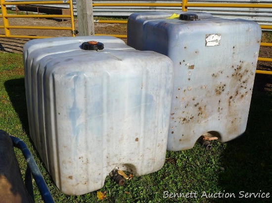 Two plastic water storage tanks. Largest is 300 gallon.