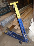 Heavy duty floor hydraulic floor jack is approx. 4' long. Raises and lowers.