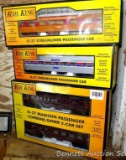 Four Rail King model trains with original boxes. All trains look to be in good condition, boxes are