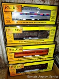 Four Rail King model trains with original boxes. All trains look to be in good condition, tears