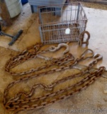 Two lengths of chain, U-hook, and a metal crate. Longer length of chain has 3