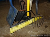 Quickie Jobsite push broom, flat shovel, small pitchfork and a dustpan. Broom has a 24