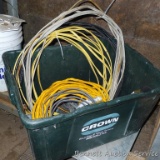 Plastic tote filled with electrical supplies, includes red and yellow wire nuts, wire, extension