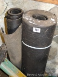 Two partial rolls of roofing felt. Larger roll is 8