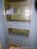 Metal storage cabinet with adjustable shelves and has pull out storage containers for nuts and