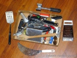 Kitchen utensils including wooden spoon, flippers, strainer, grater, meat mallet, measure spoons,