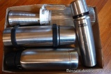 Three stainless thermos'; stainless measure; one quart glass carafe;