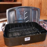 Heavy anodized roasting pan with two racks and a serving platter.