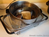 Heavy duty strainer with expanding side arms; stainless steel strainer is nearly 10