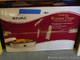 Rival Family Size Roaster Oven can cook an 18 lb turkey. Heats and comes with manual. Looks like