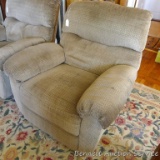 Comfortable rocking recliner matches Lot 794. Nice neutral colors. Some stains or dirt, hopefully