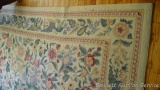 Floral patterned area rug is about 11' x 8' and in decent condition.