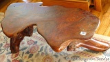 Wonderful slab wood coffee table with tree trunk feet. Measures 45