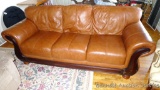 Nice comfortable leather couch has five legs and is very sturdy. We think this is leather, but
