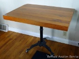 Casters have been added to this table with an antique cast iron base. Table top measures 3' x 27