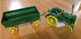Two Ertl die cast John Deere toys. Steel wheel tractor replica has 5700-9415 and 5700-9216 on