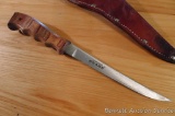 Sharp filet knife is nearly a foot long and comes with a leather sheath.