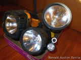 Three lanterns and two small flashlights. One lantern lights and one flashlight lights with blue and