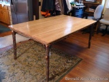 Wonderful dining table has a hickory top and rustic legs and accent pieces. Measures approx. 42