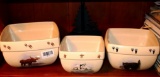 Nesting set of mixing bowls with a Northwoods theme, plus a moose napkin holder. Largest bowl