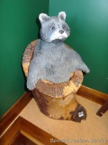 Carved stump stands nearly 2' tall and has a carved racoon or bear on top.